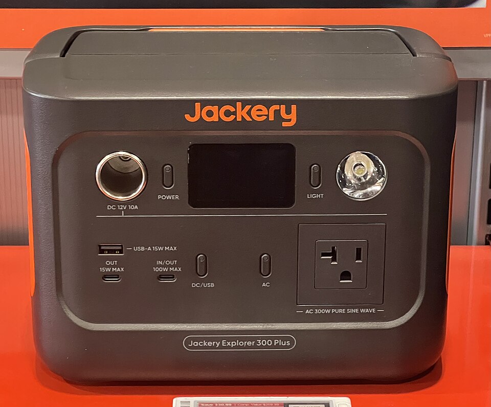 A dark gray Jackery Explorer 300 Plus power station with a display, USB ports and an AC outlet on the front, for storm prep in Iowa City, IA