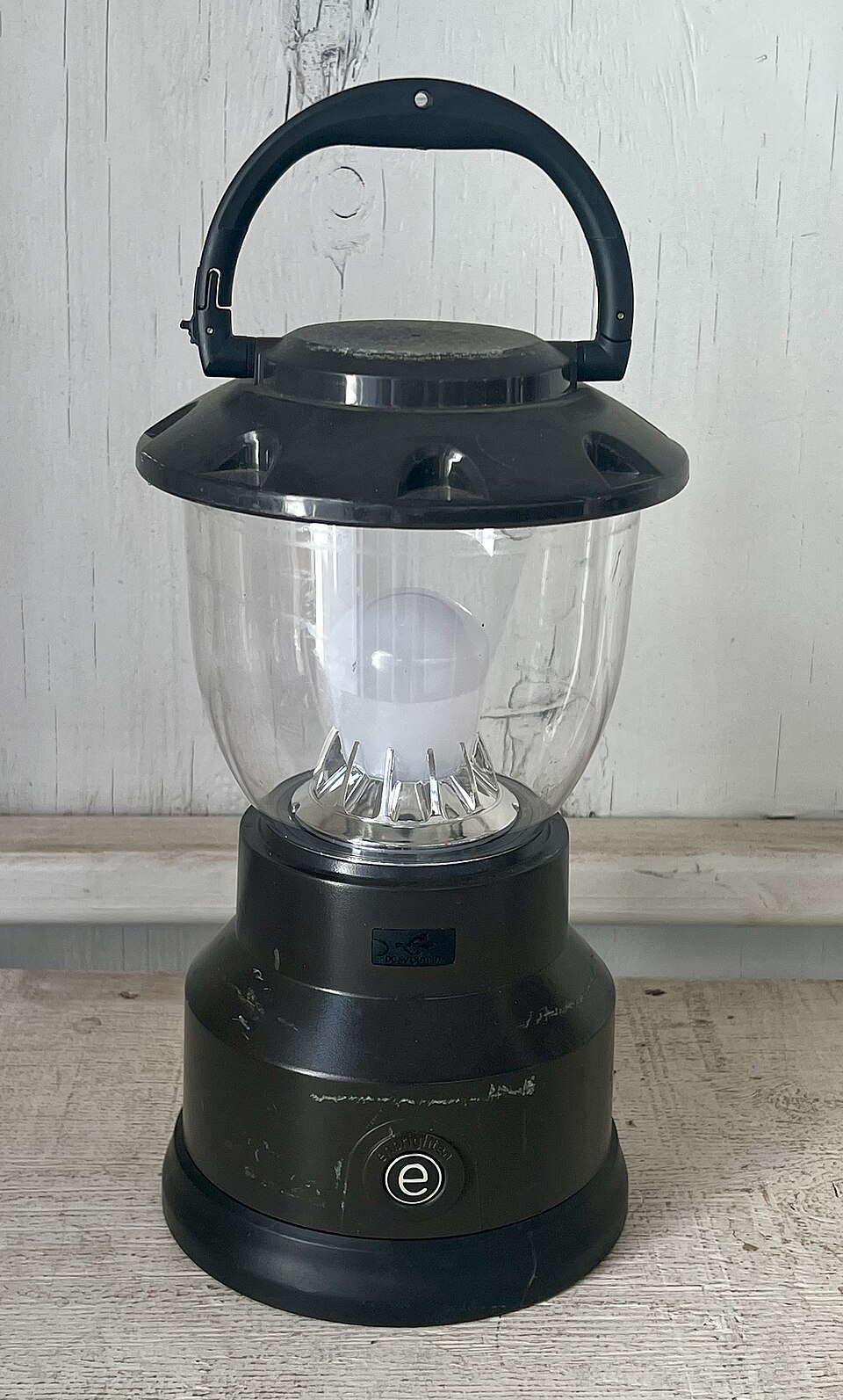 A black LED camping lantern with a clear globe and a top carry handle, for storm prep in Iowa City, IA