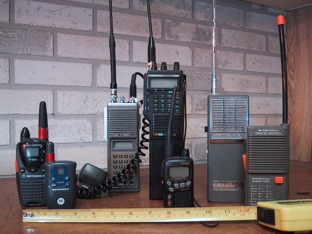 Several handheld walkie-talkies of different makes standing side by side, for storm prep in Iowa City, IA